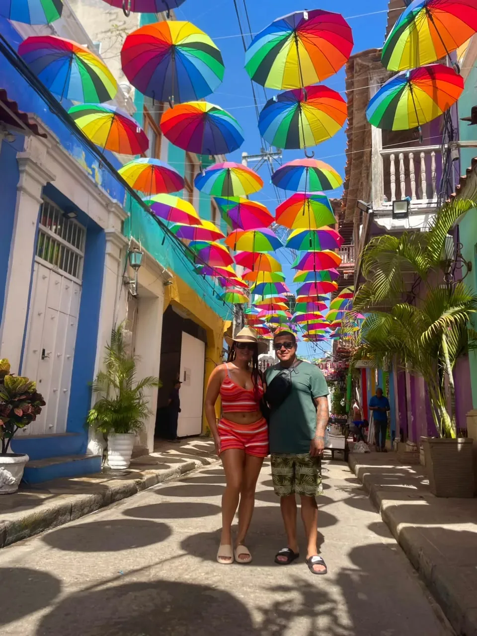 Colourful umbrellas hanging over a street in the walled city