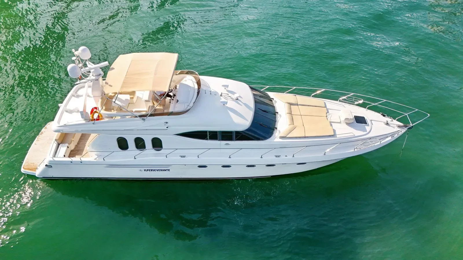 Drone shot of a yacht crossing turquoise Caribbean water